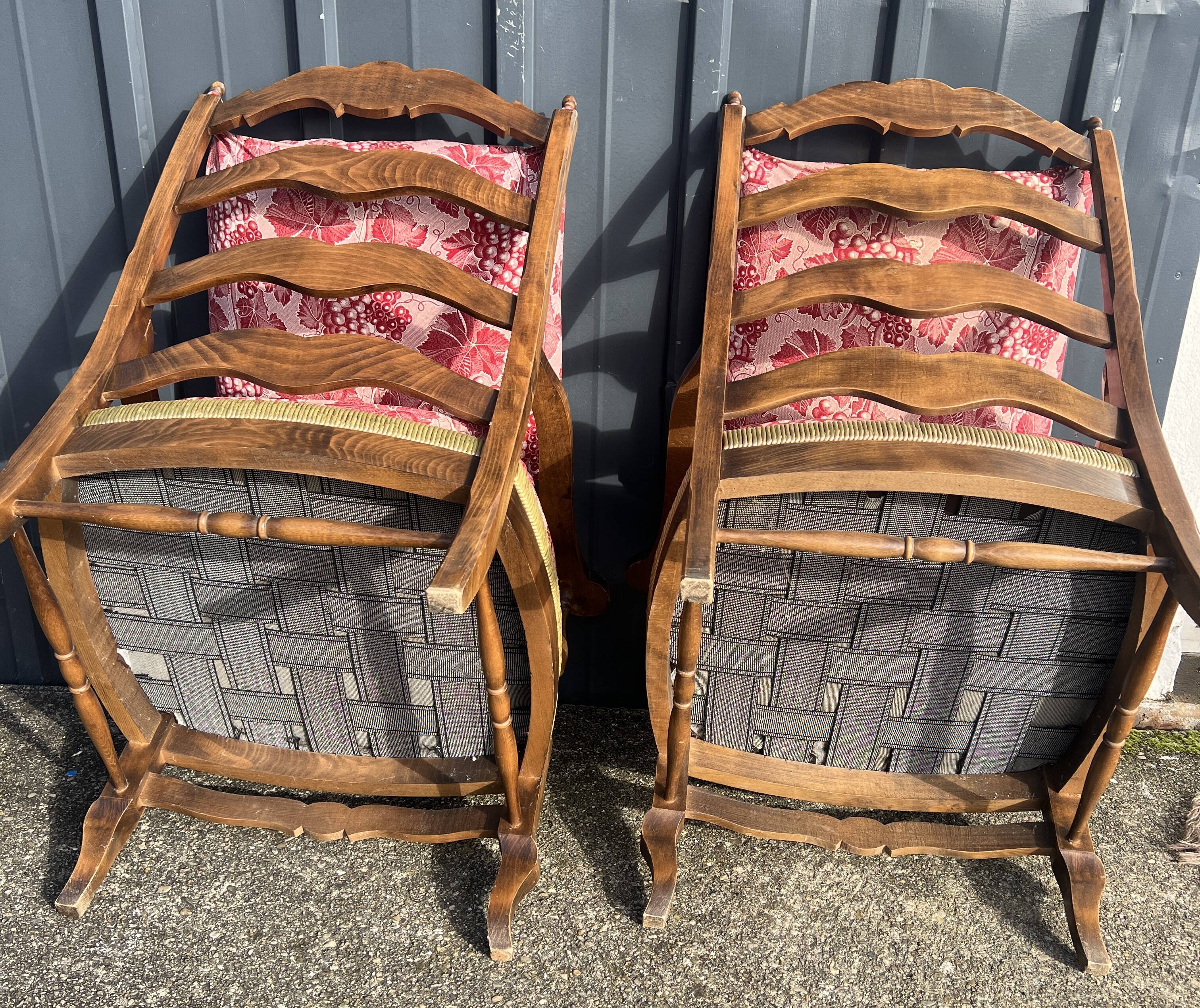 pair of rustic wood and fabric armchairs