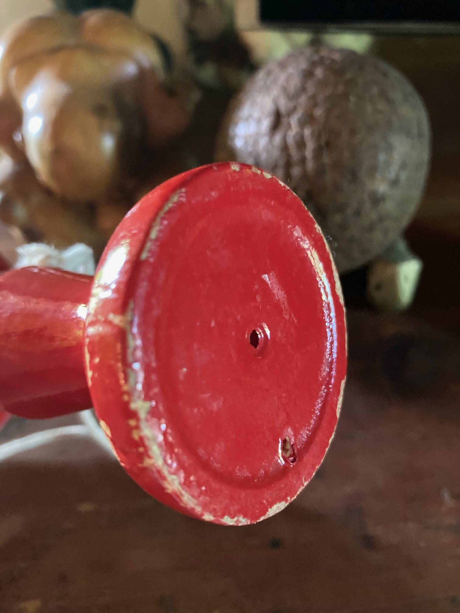 Large red wooden cup-and-ball game, 9 cm in diameter.