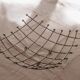 Curved grid fruit bowl, chrome metal and beads.