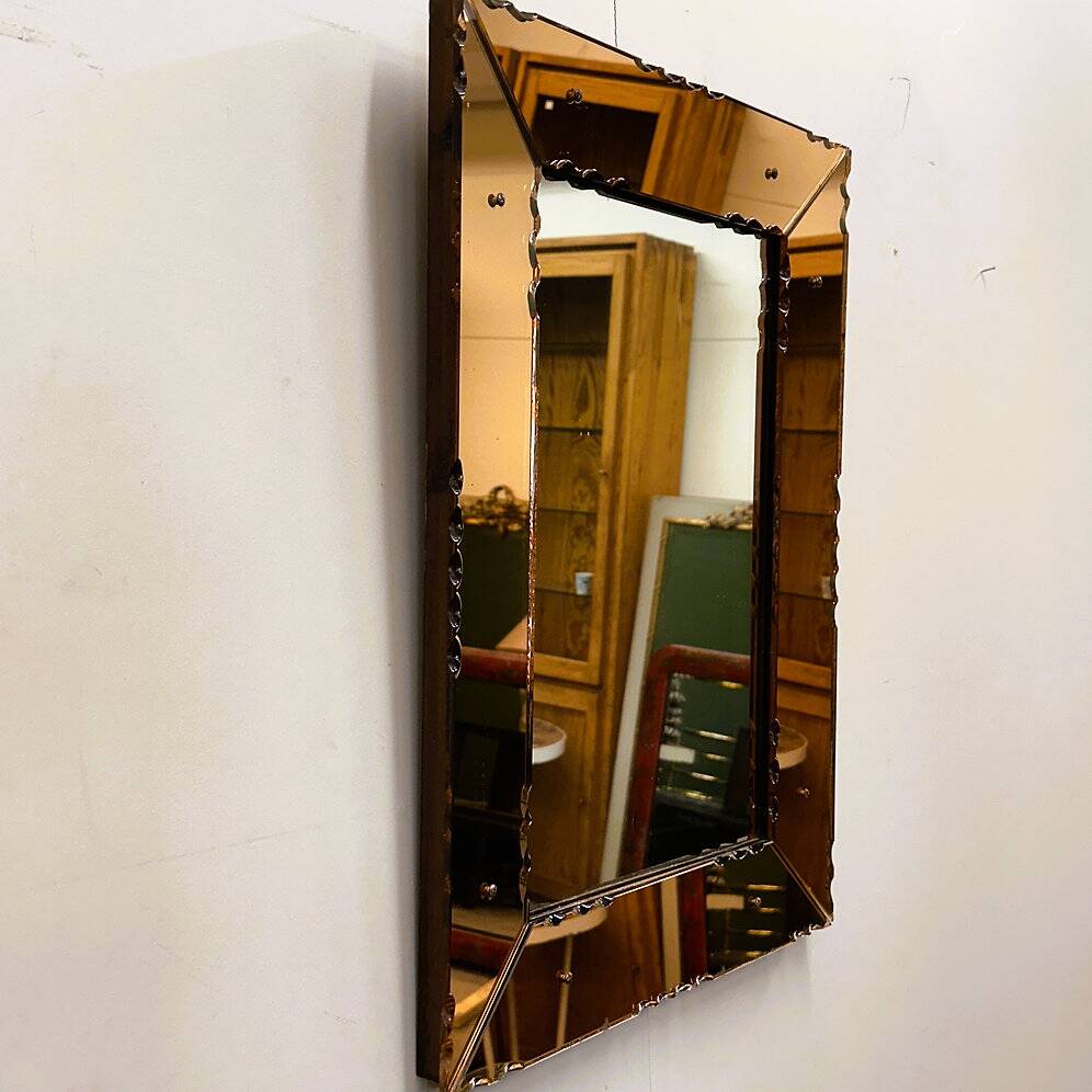 Striking French amber-coloured mirror with sculpted edge details, 1940s