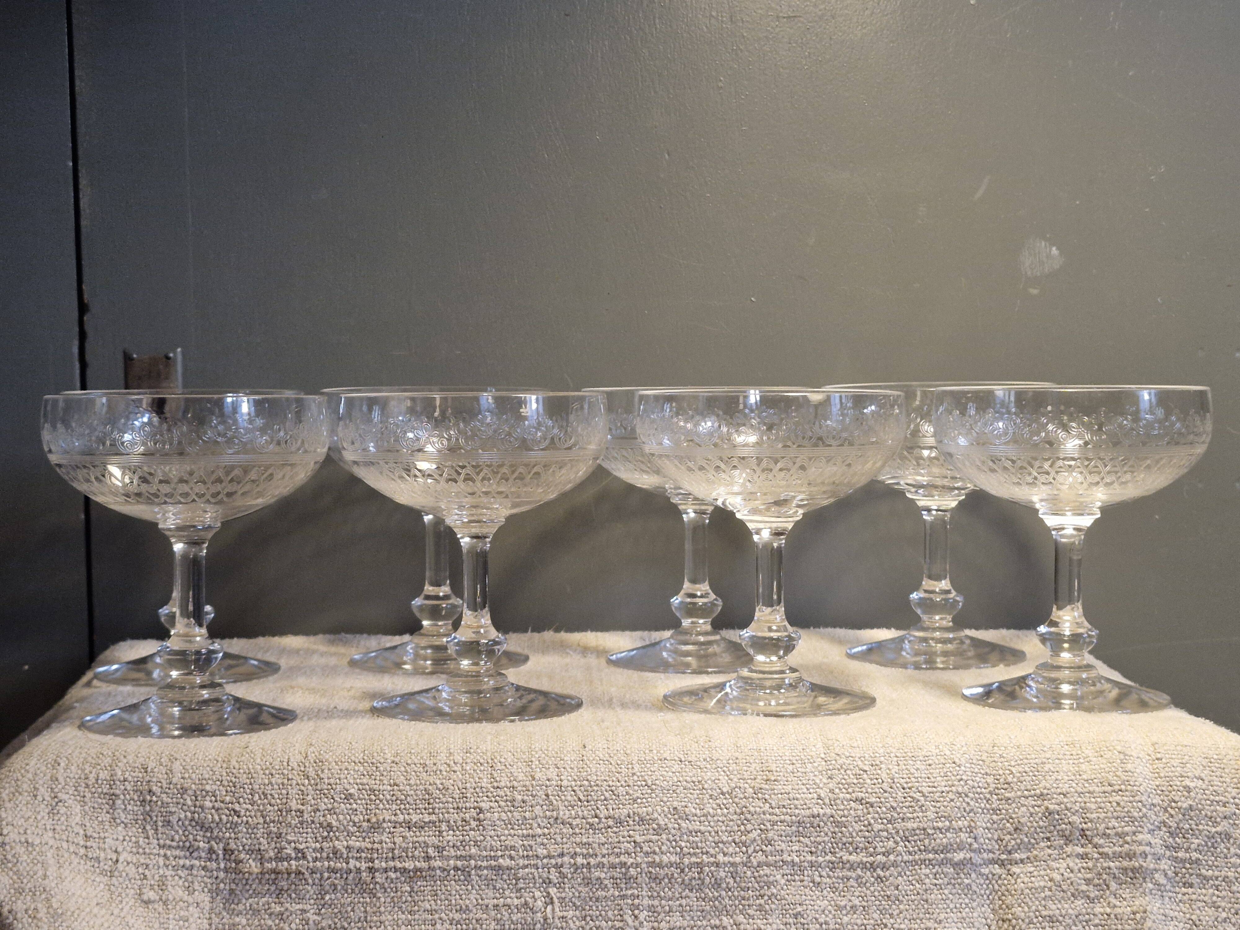 8 antique Baccarat crystal champagne coupes with engraved decoration.