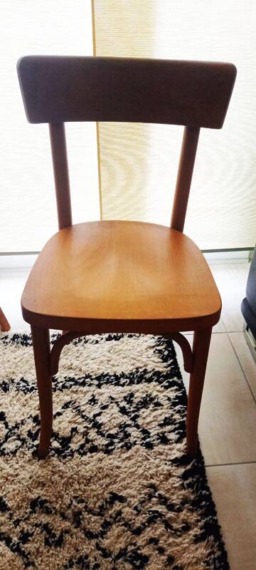 Set of 4 light wood bistro chairs stamped Baumann and Thonet.