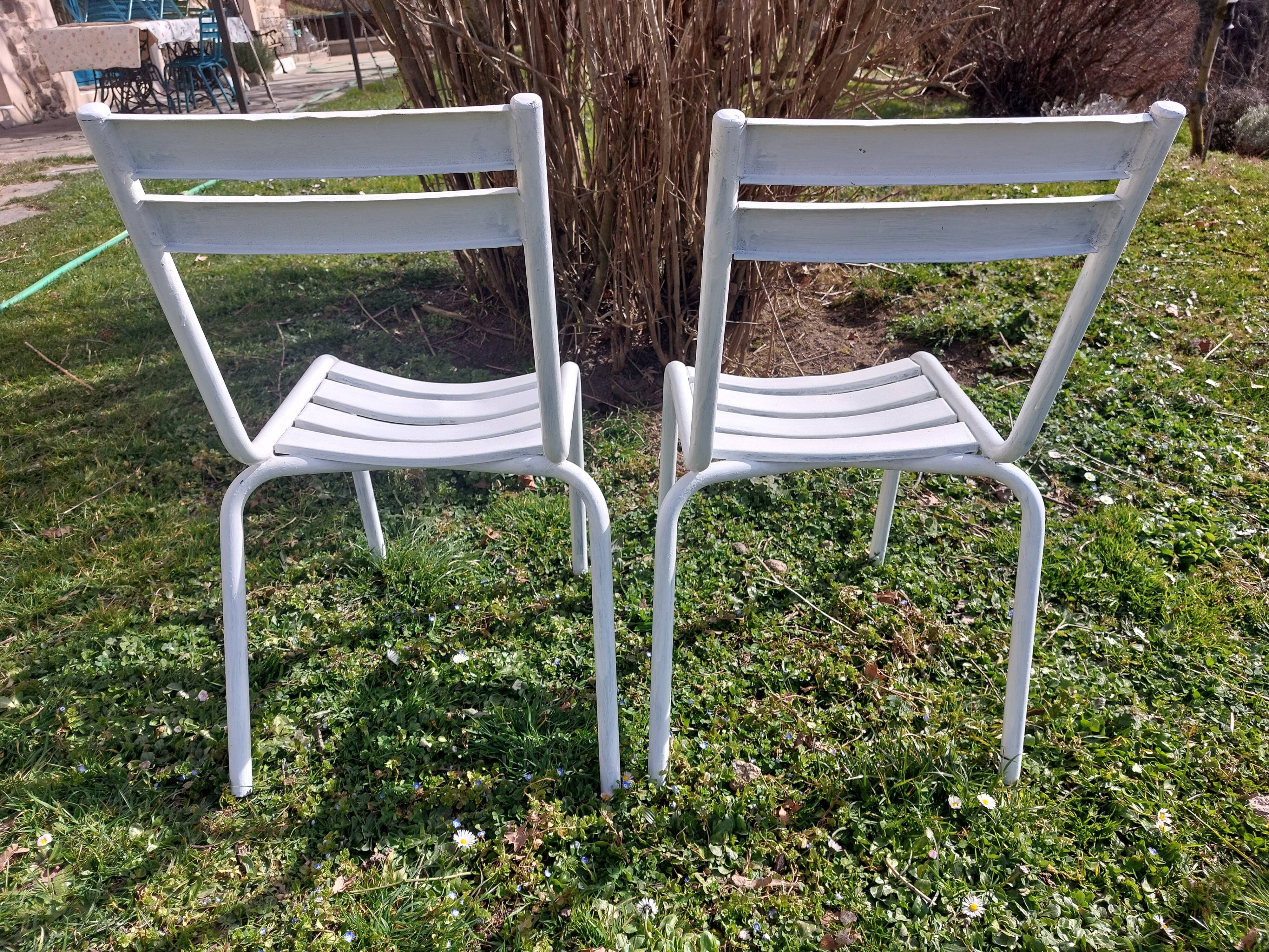 pair of white metal chairs, Tolix style