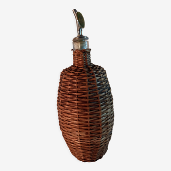 Vintage glass bottle and woven wicker