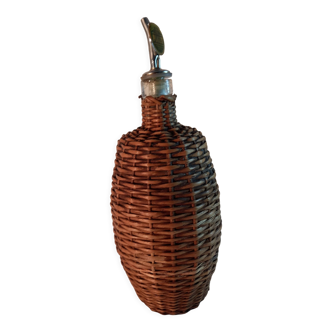 Vintage glass bottle and woven wicker