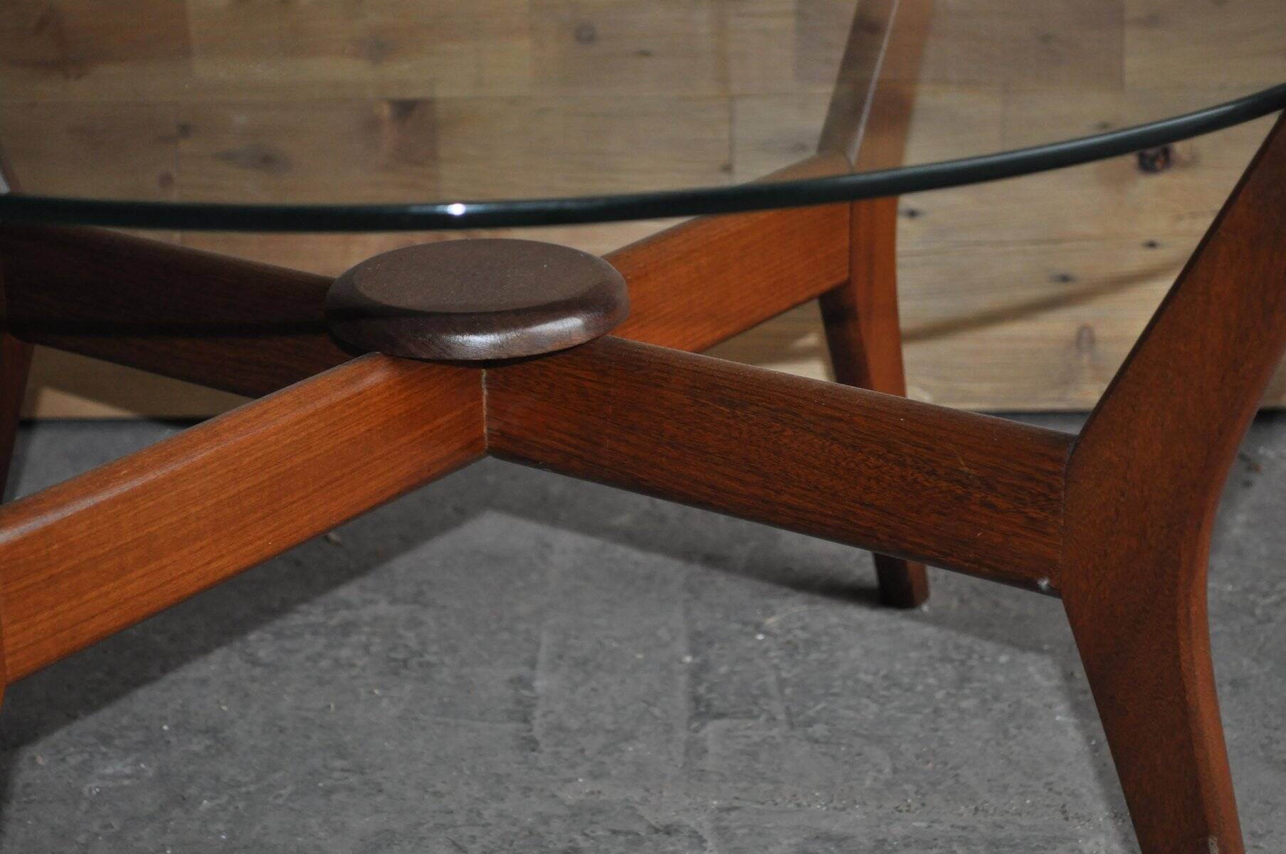 Mid-century coffee table in brown teak with a floating tempered glass top.