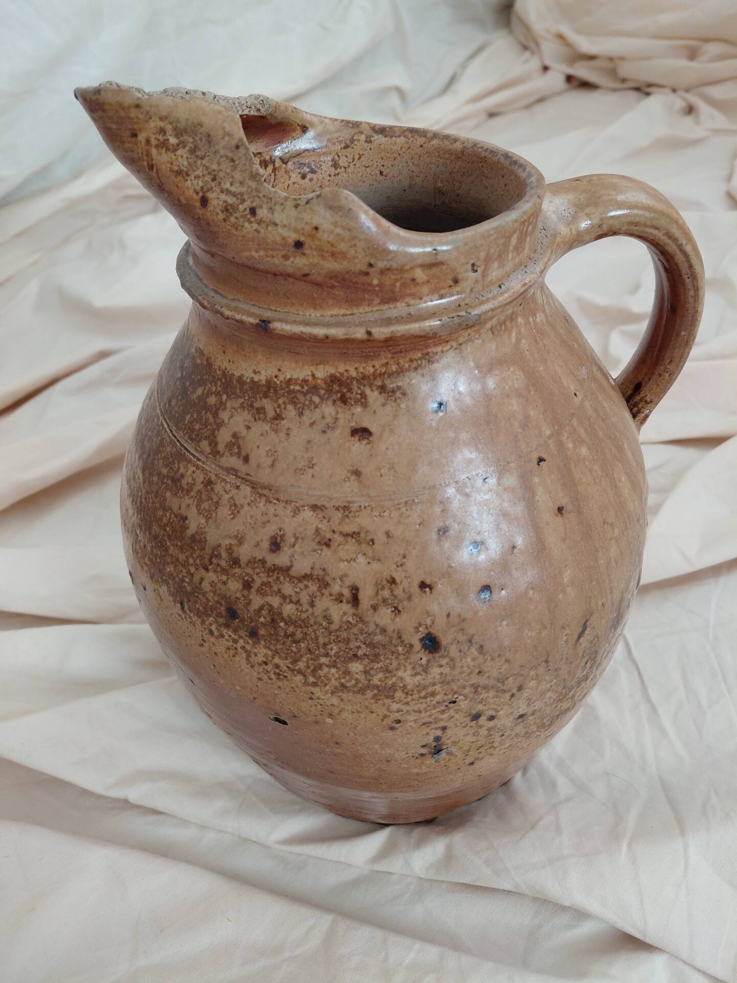 Old farm jug in glazed stoneware