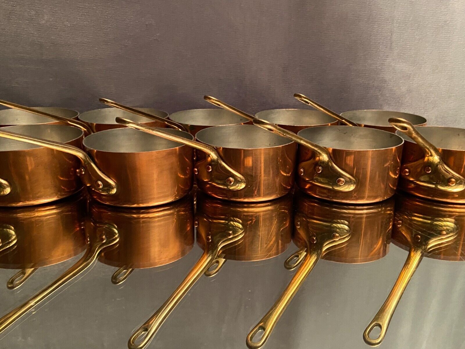Suite of 12 tinned copper pans