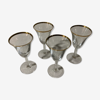 4 glasses with aperitif with golden border in blown glass