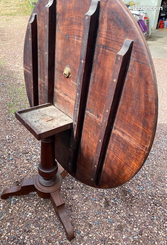Old and large round winegrower's table made of wood.
