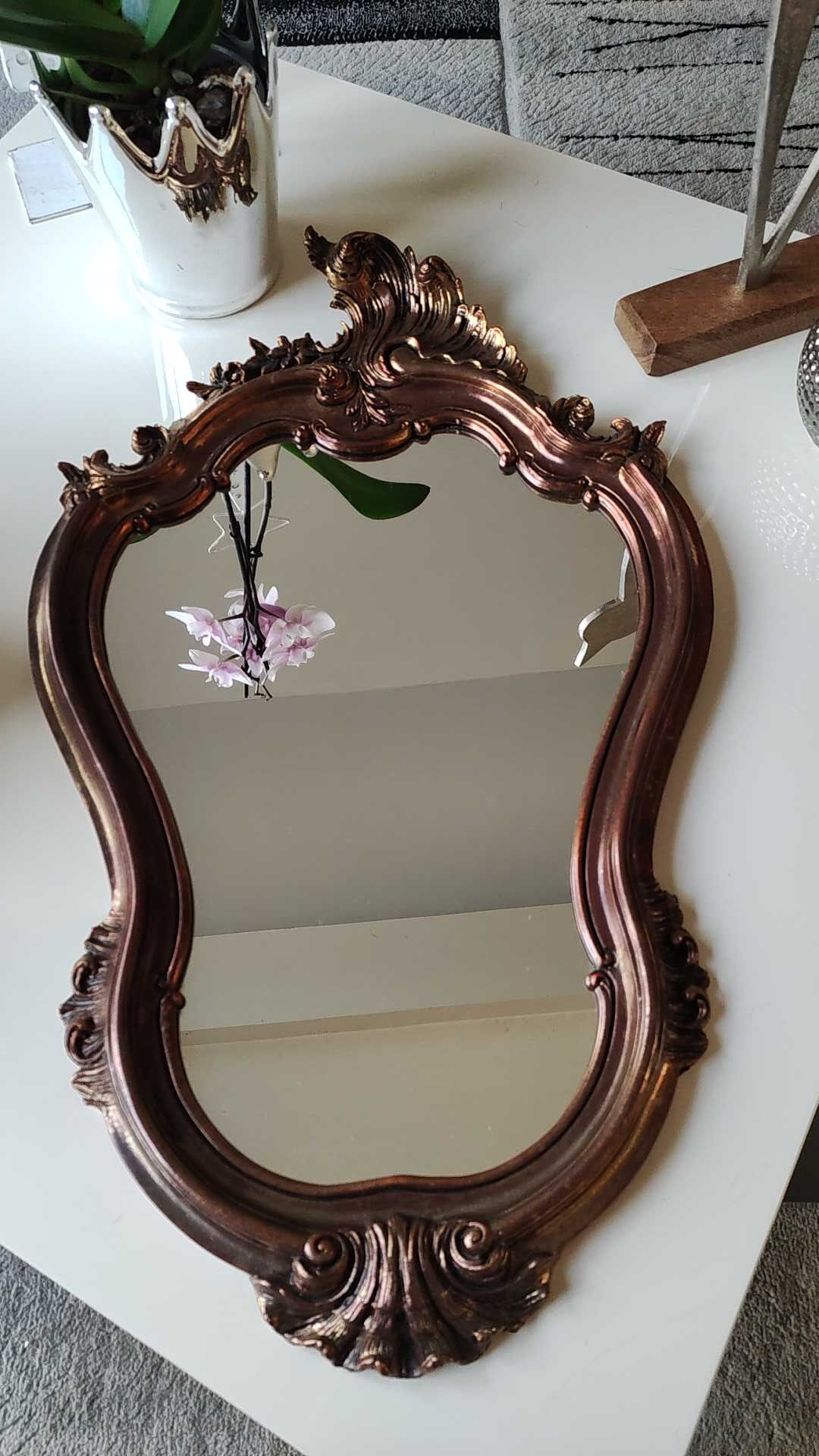 Pretty Baroque style mirror / Louis XV patinated with pink / golden copper reflections. Volutes, leafy shells