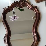 Pretty Baroque style mirror / Louis XV patinated with pink / golden copper reflections. Volutes, leafy shells