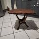 Coffee table with knotted wooden legs in an African pattern