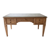 Solid wood desk with glass top and sculptures.