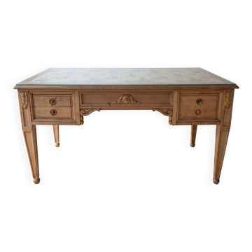 Solid wood desk with glass top and sculptures.