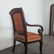 Restoration armchair in mahogany with cross arms and orange fabric.