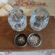 Antique salt and pepper shakers in crystal and silver metal.