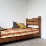 Brutalist style bed with chain and straw