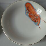 Eight hollow plates decorated with lobsters