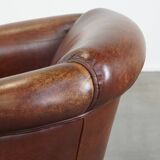 Sheepskin club armchair, correct finishing with decorative nails