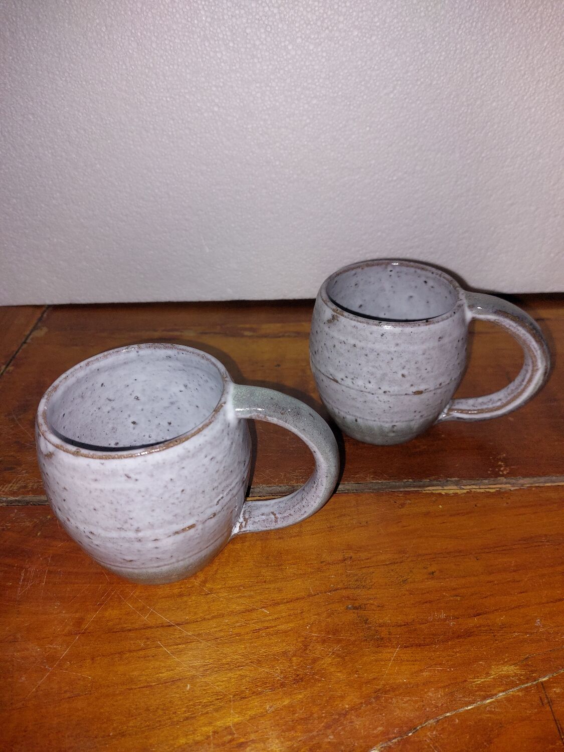 Two glazed stoneware mugs