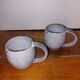 Two glazed stoneware mugs
