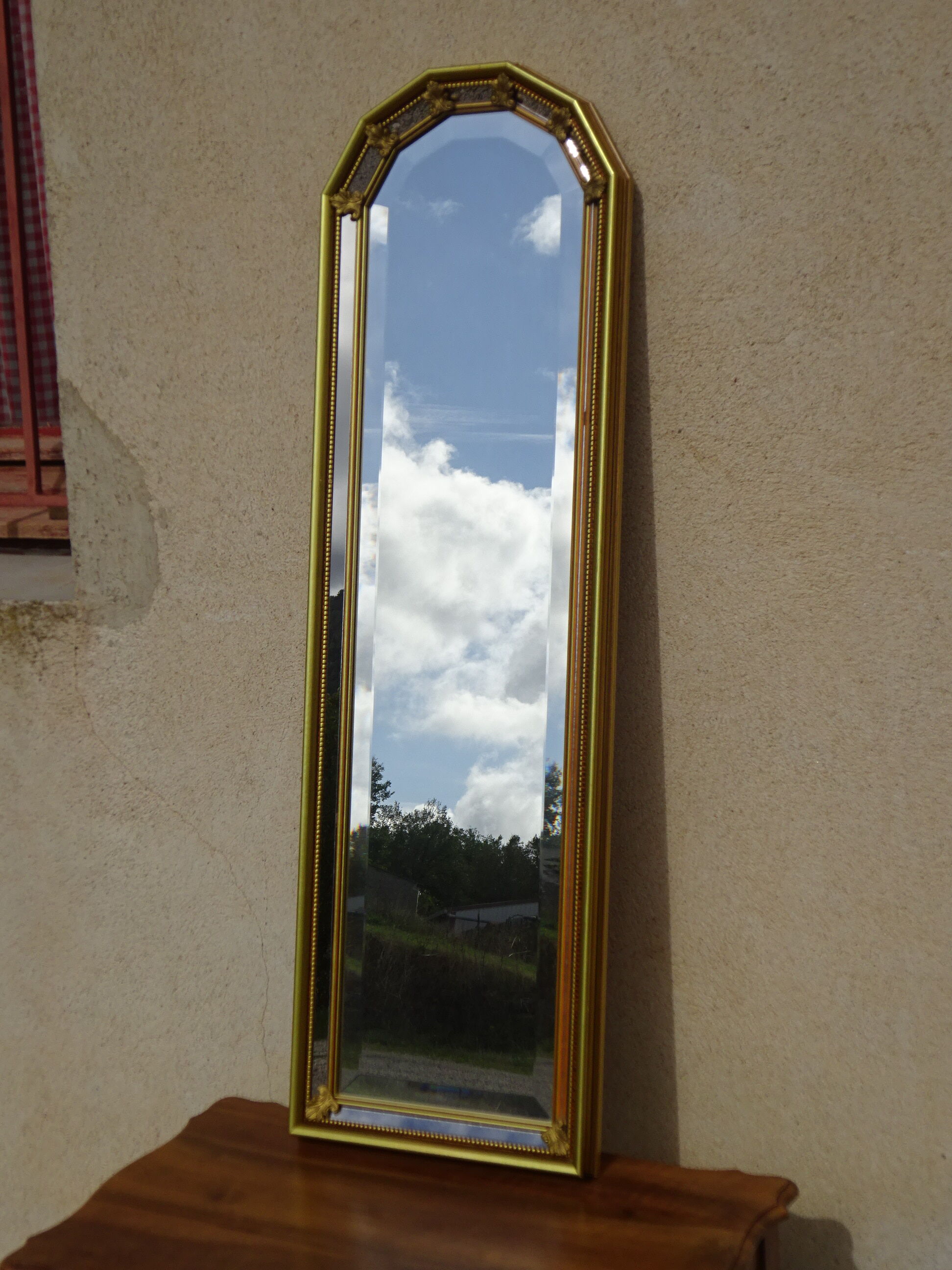 Vertical mirror, gold frame with beading.