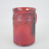 Red glazed ceramic jug with relief