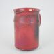 Red glazed ceramic jug with relief