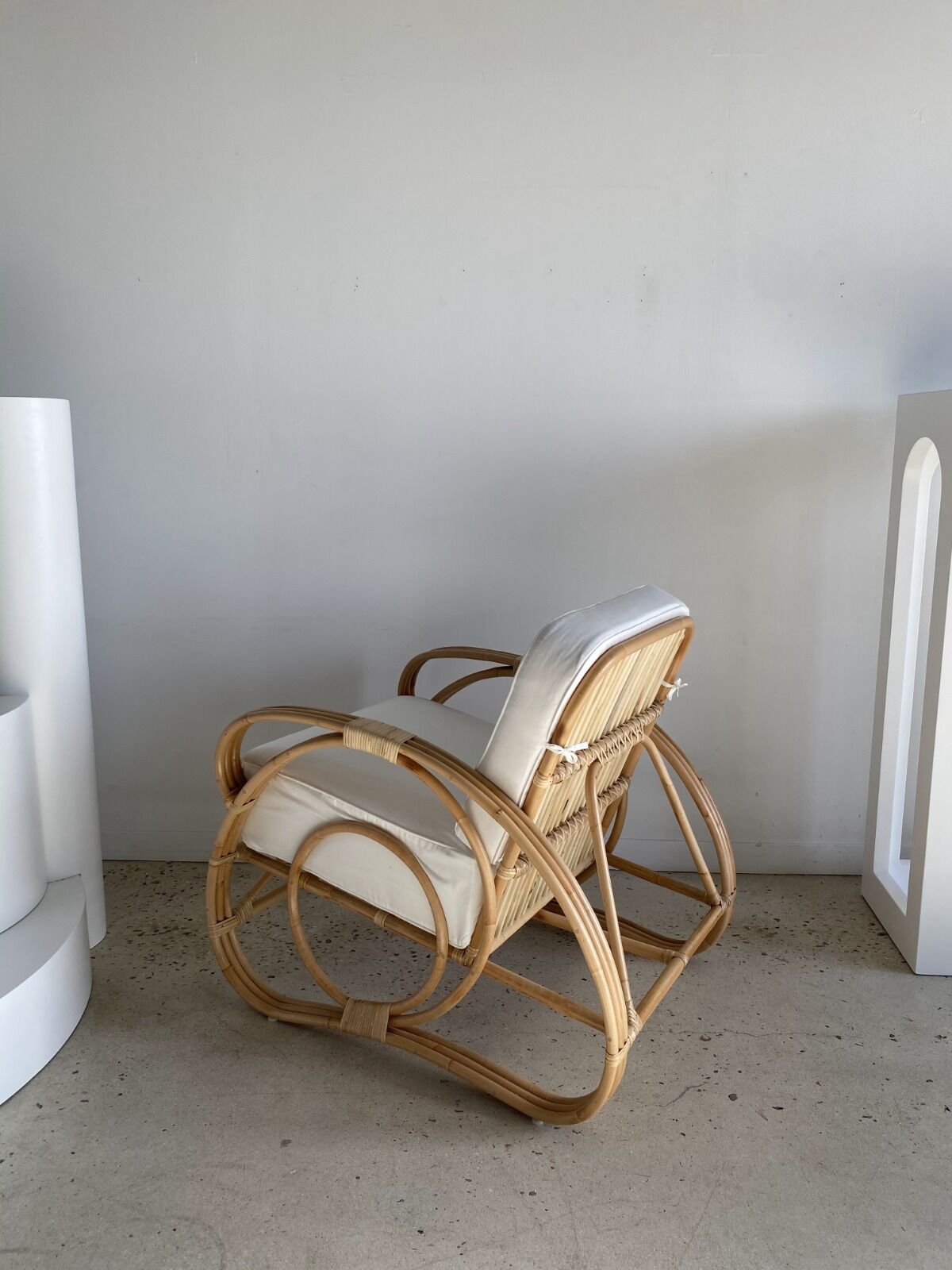 Large rattan rest chair and white cushions