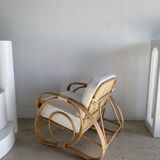 Large rattan rest chair and white cushions