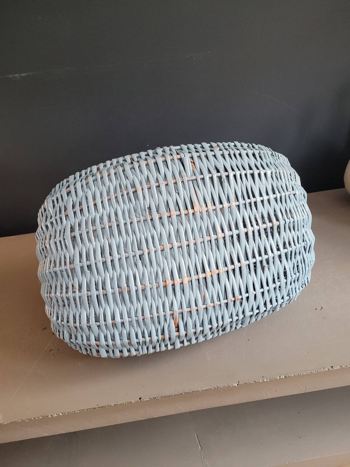 Turquoise-painted wicker basket