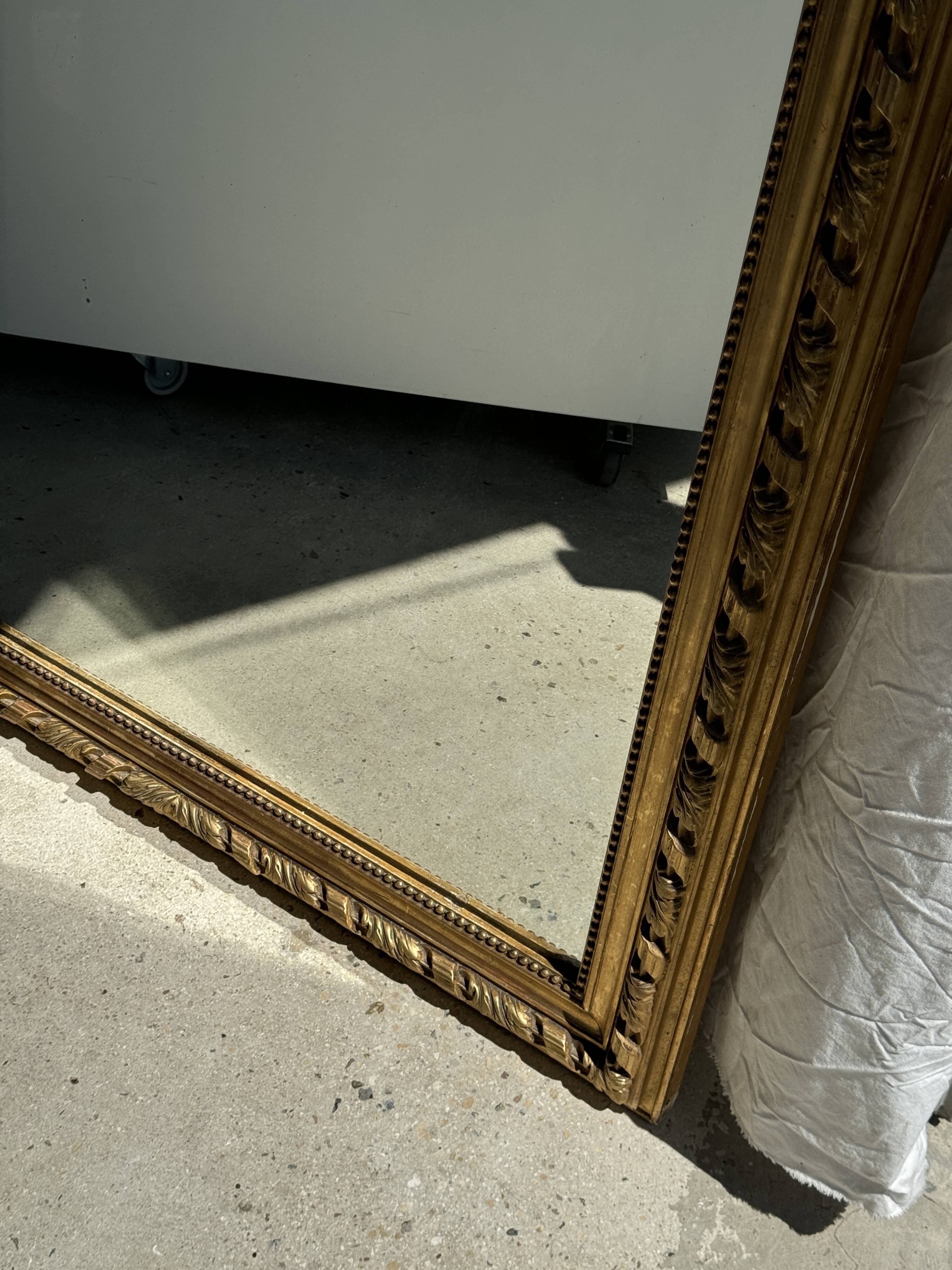 Large gilded mirror with acanthus leaf pediment H150 L98