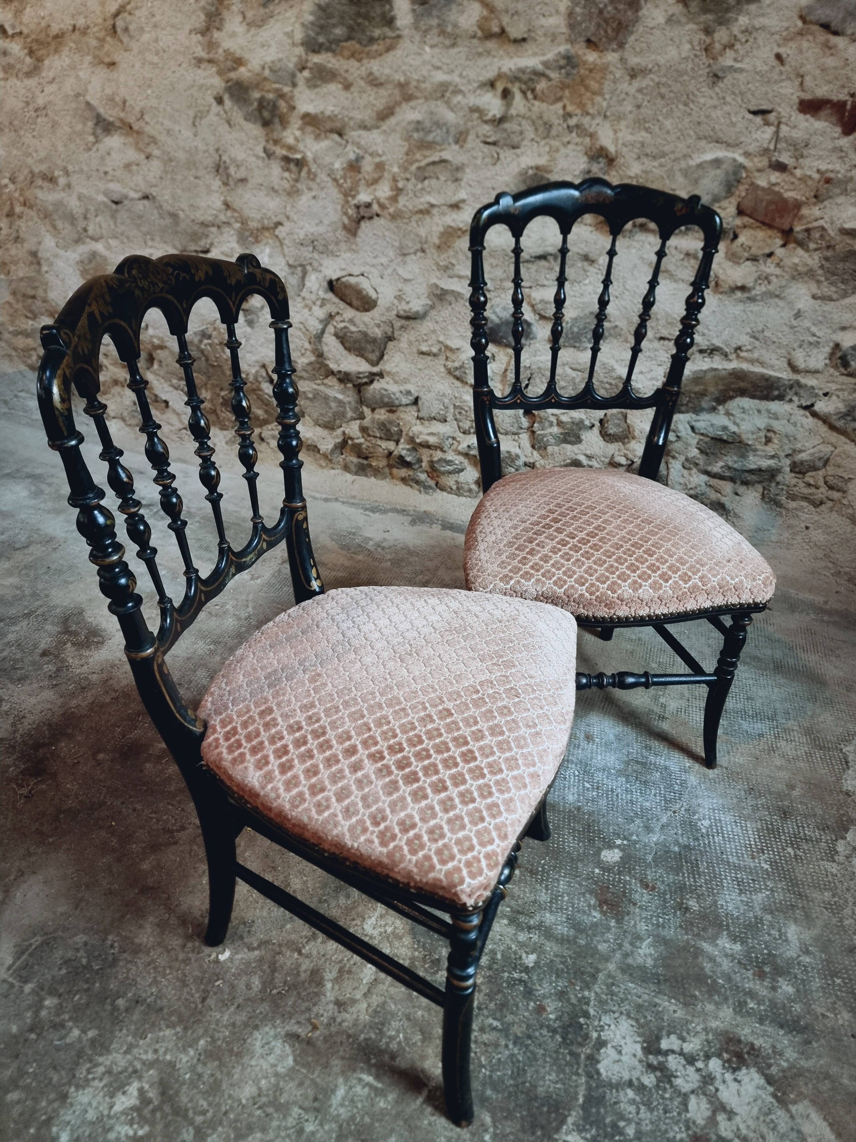 Pair of antique Napoleon III chairs in blackened wood and fabric.
