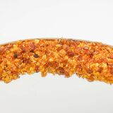 Circular and backlit mirror in amber. Contemporary artist's work.