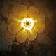 Flower wall light made of rattan and raffia petals