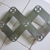 Expandable stainless steel trivet from the 50s and 60s