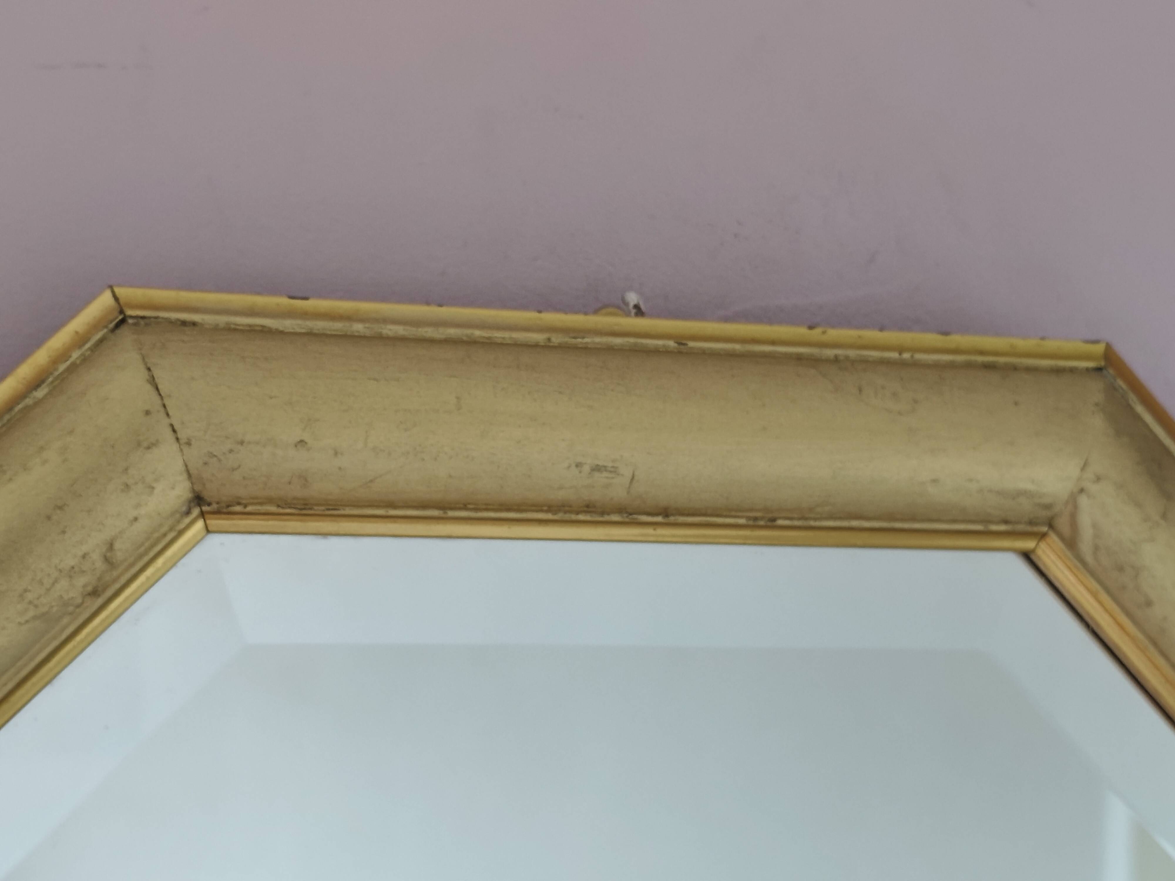 Golden octagonal mirror with bevelled glass from the 1970s.