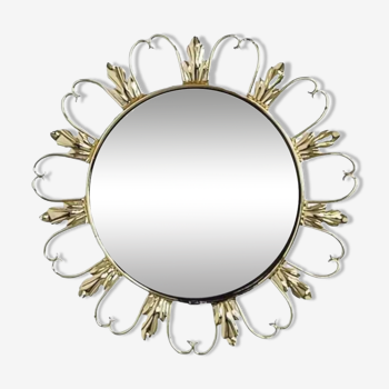 Round mirror on brass frame with scrolls