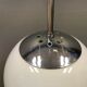 White hanging lamp with metal suspension, made with ball round opal glass shade.