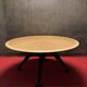 Round wooden and metal quadripod dining table