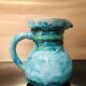 Old pitcher in terracotta signed