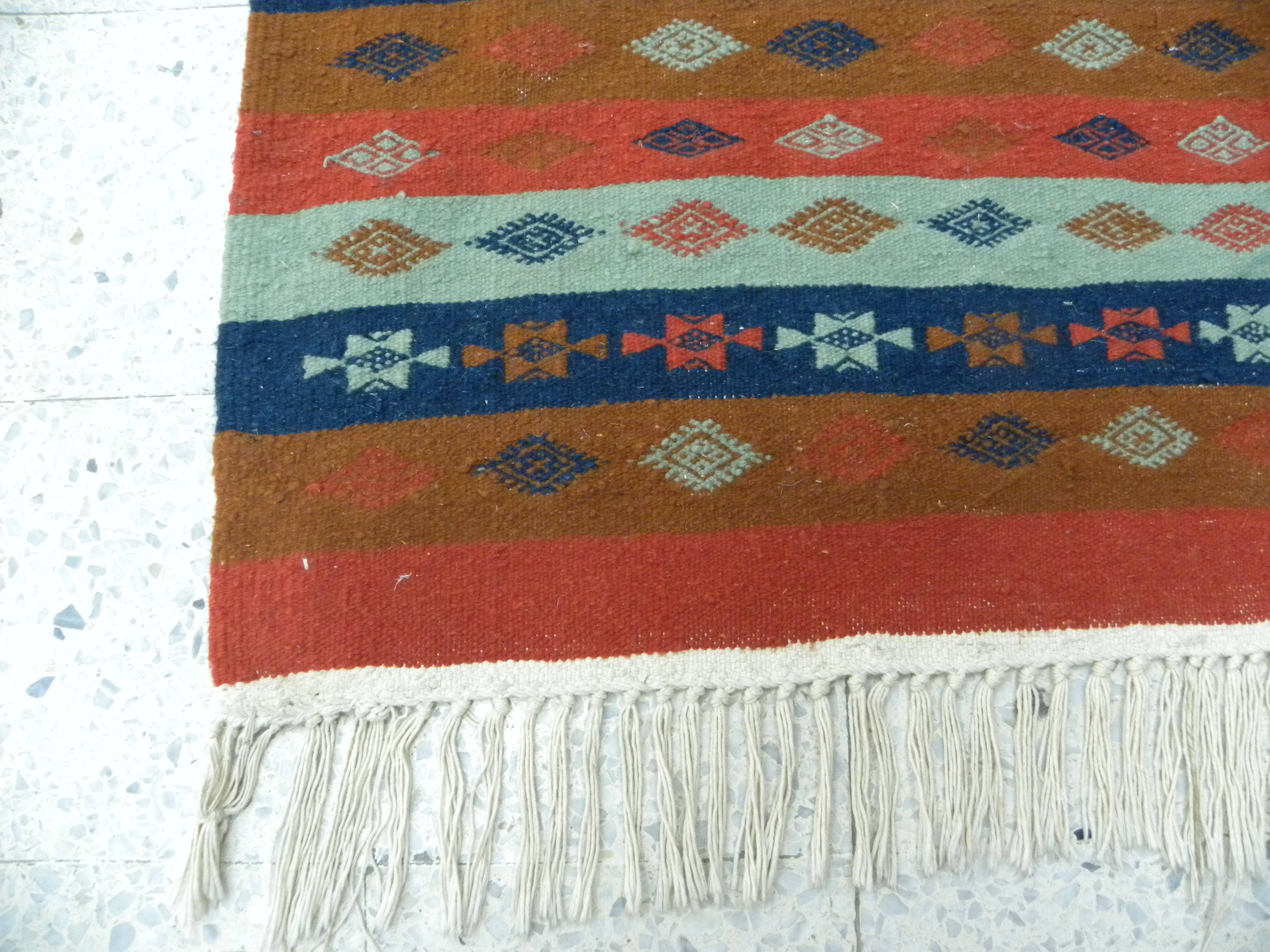 Authentic handmade Tunisian Berber kilim rug in orange wool.
