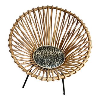 Wicker armchair and sun metal