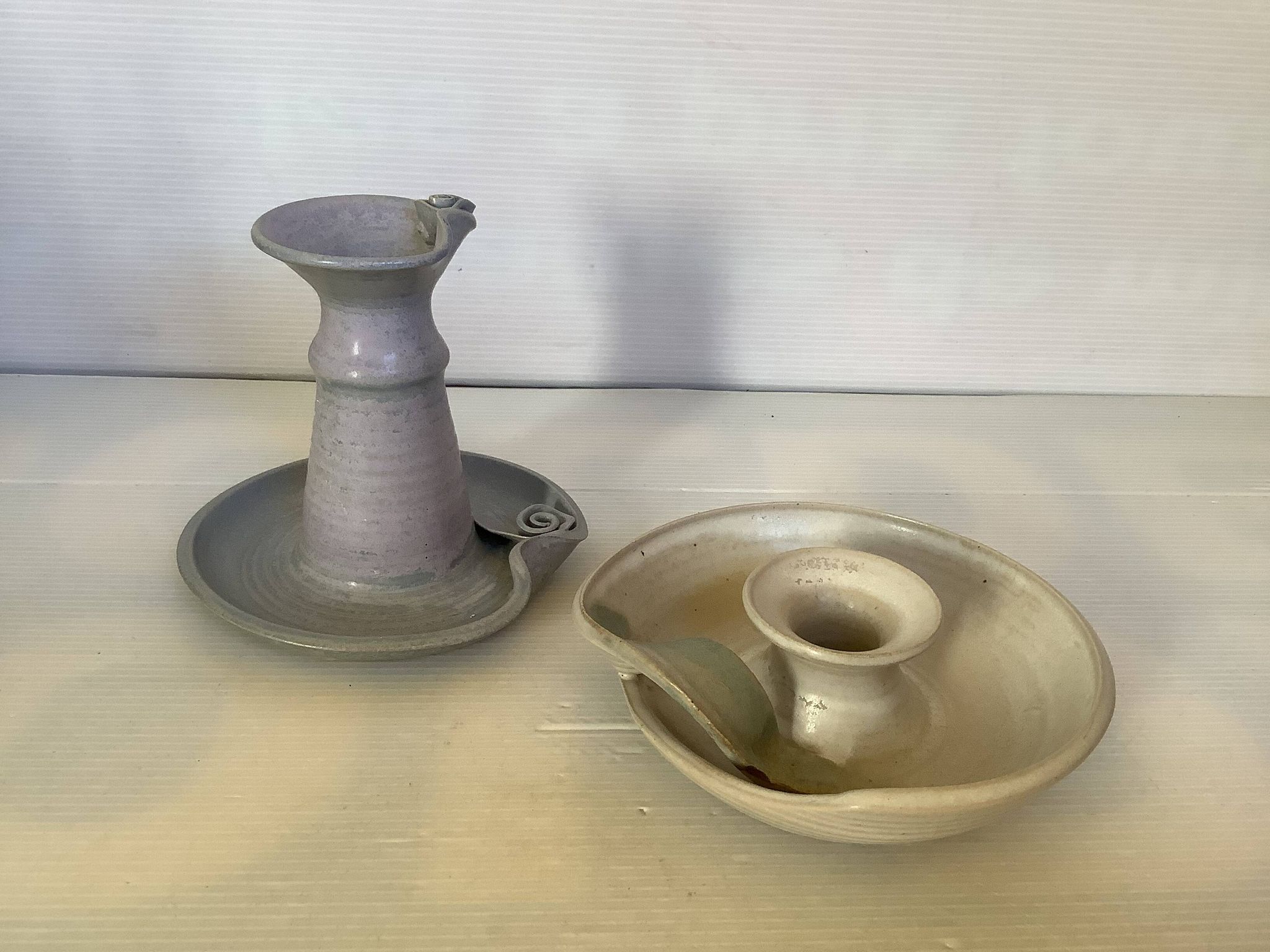 Pair of signed ceramic candlesticks