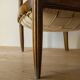 Antique armchair in solid wood and patinated brown leather, early 20th century.