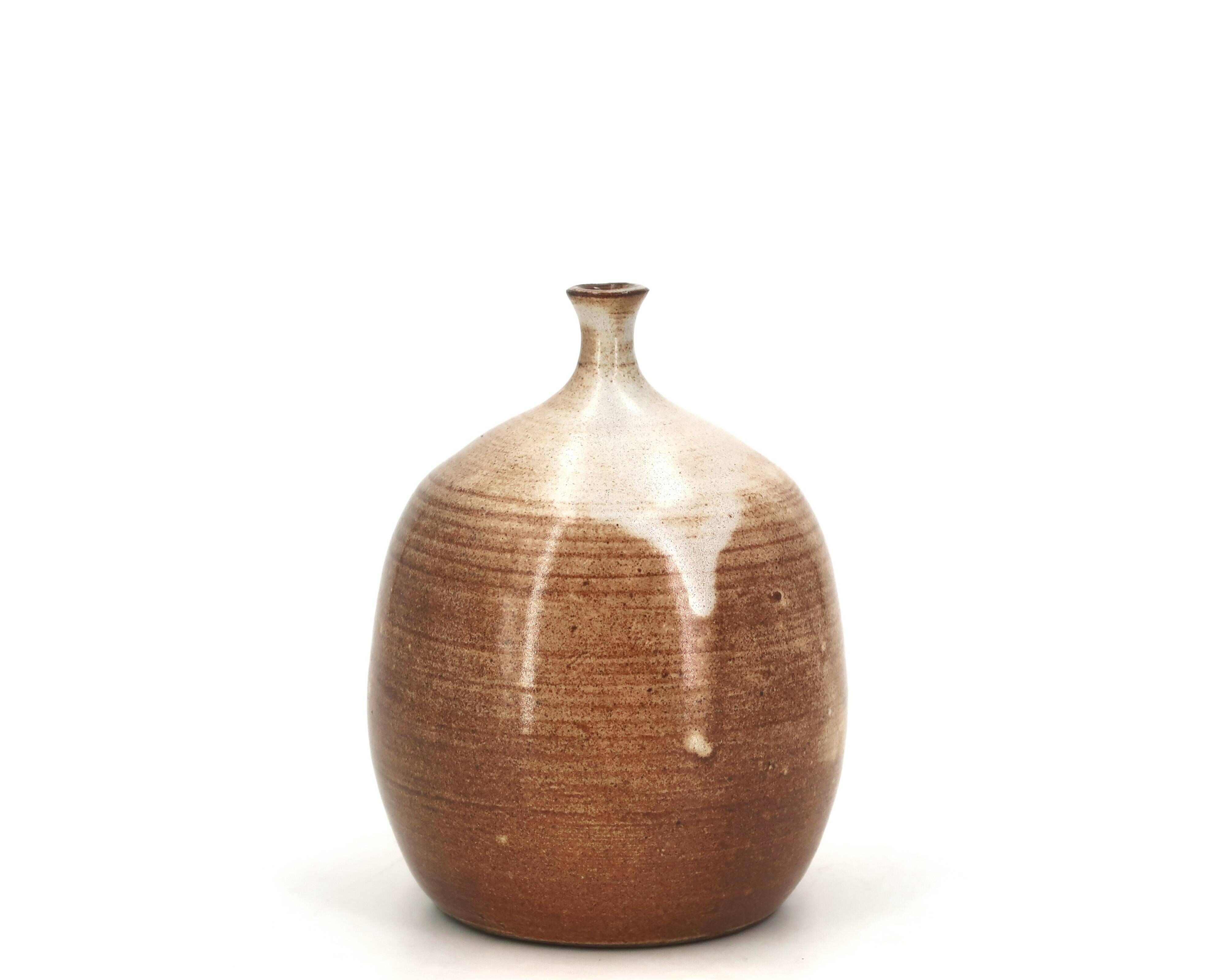 Ovoid vase with a small neck in brown beige ceramic and white drips.