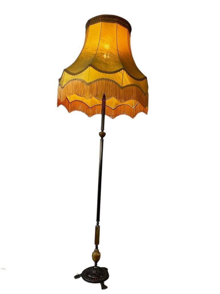 Vintage gold floor lamp with fringed shade.