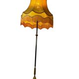 Vintage gold floor lamp with fringed shade.