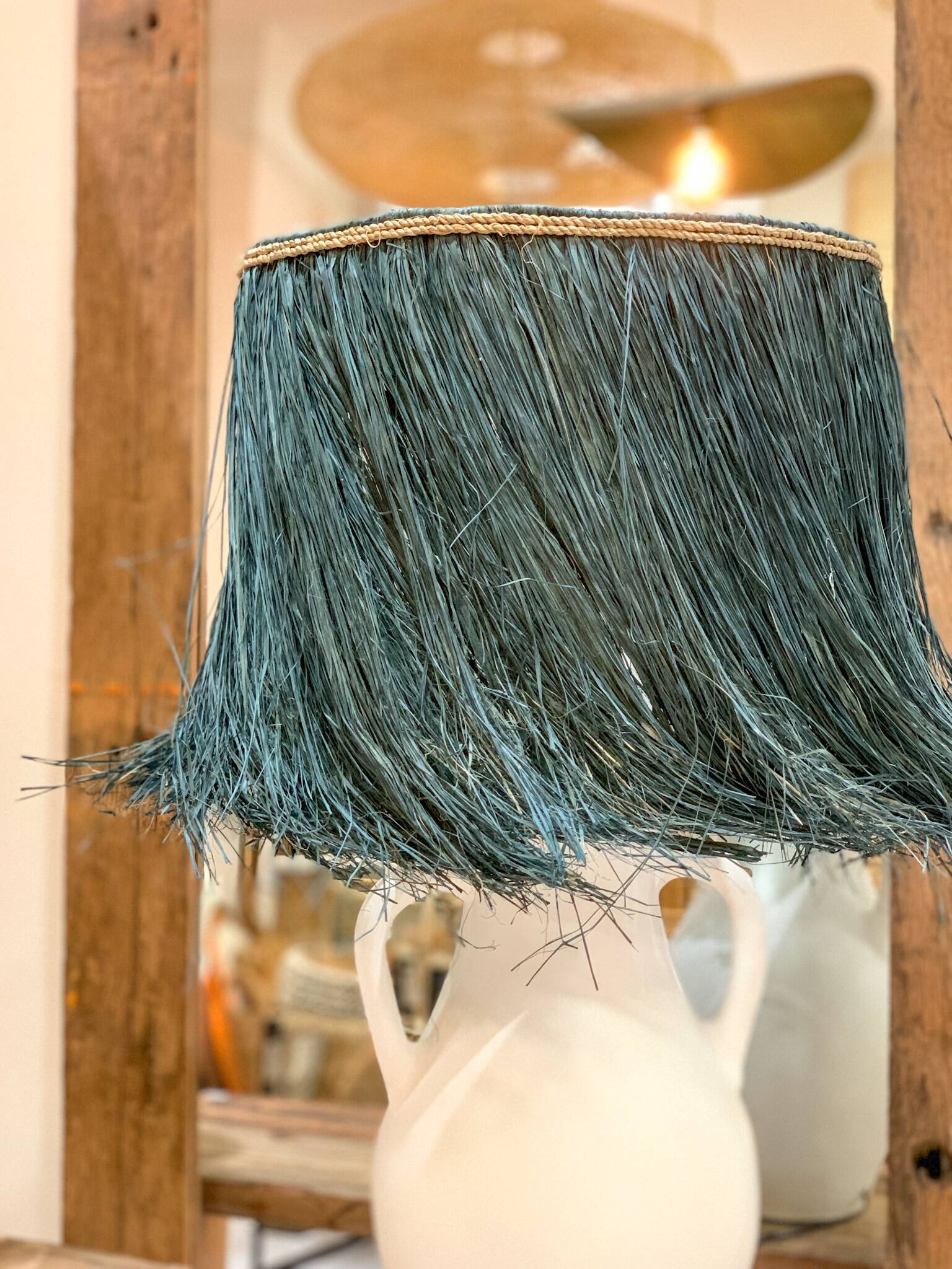 White terracotta lamp and blue raffia lampshade